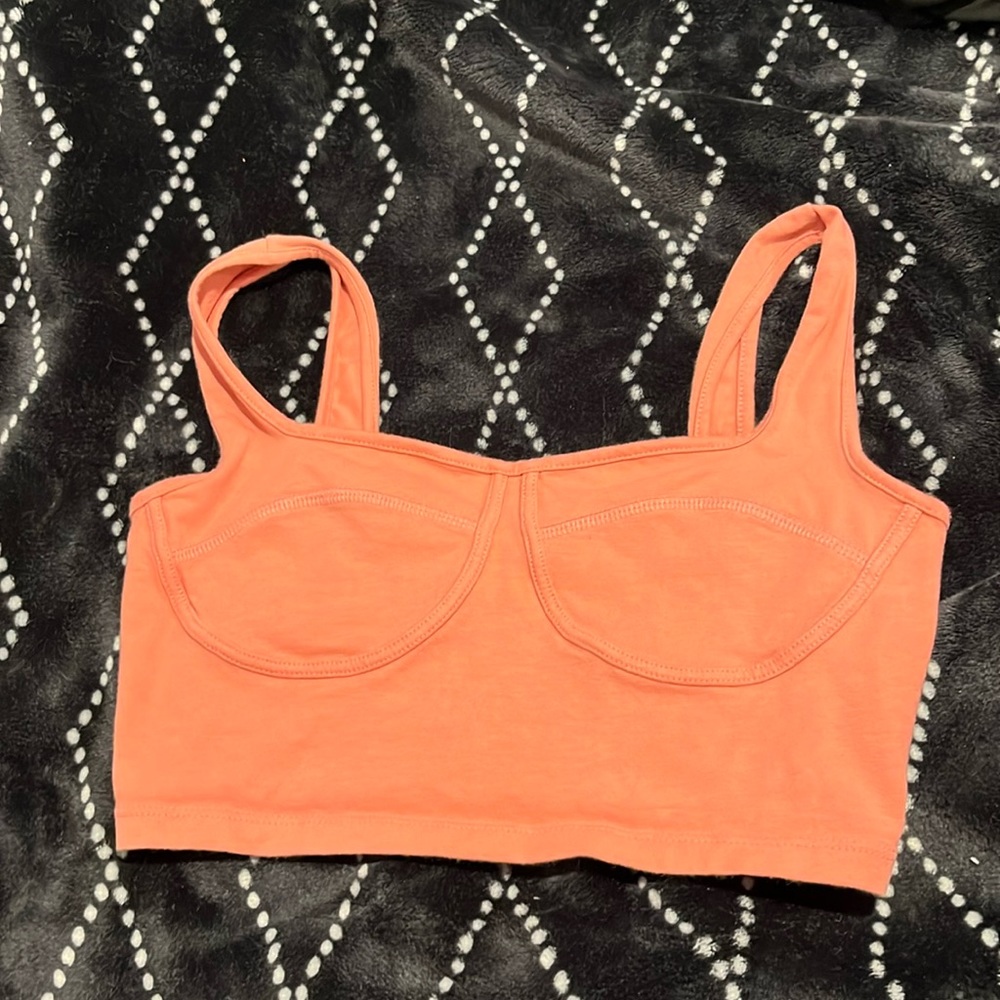 A pink crop top/ sports bra.